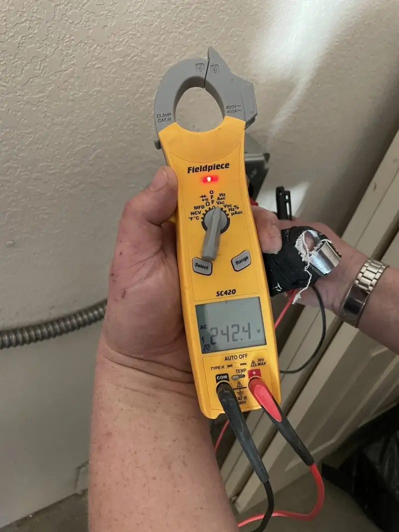Voltage testing with clamp meter during Recessed Lighting Installation in Rayne
